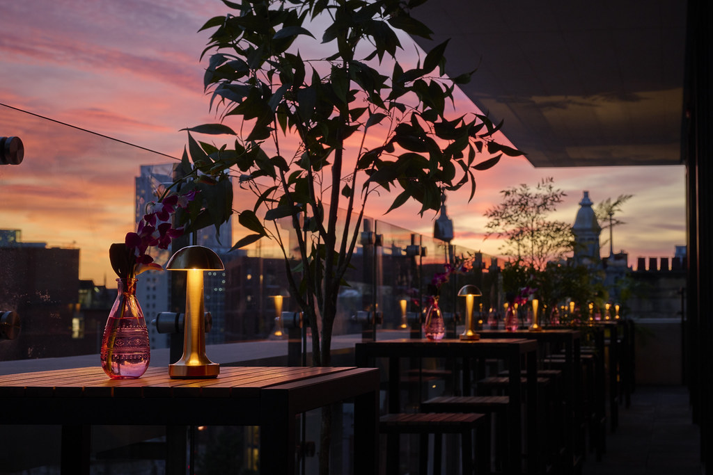 Private outdoor event space at Malmaison Deansgate Hotel with sunset backdrop.