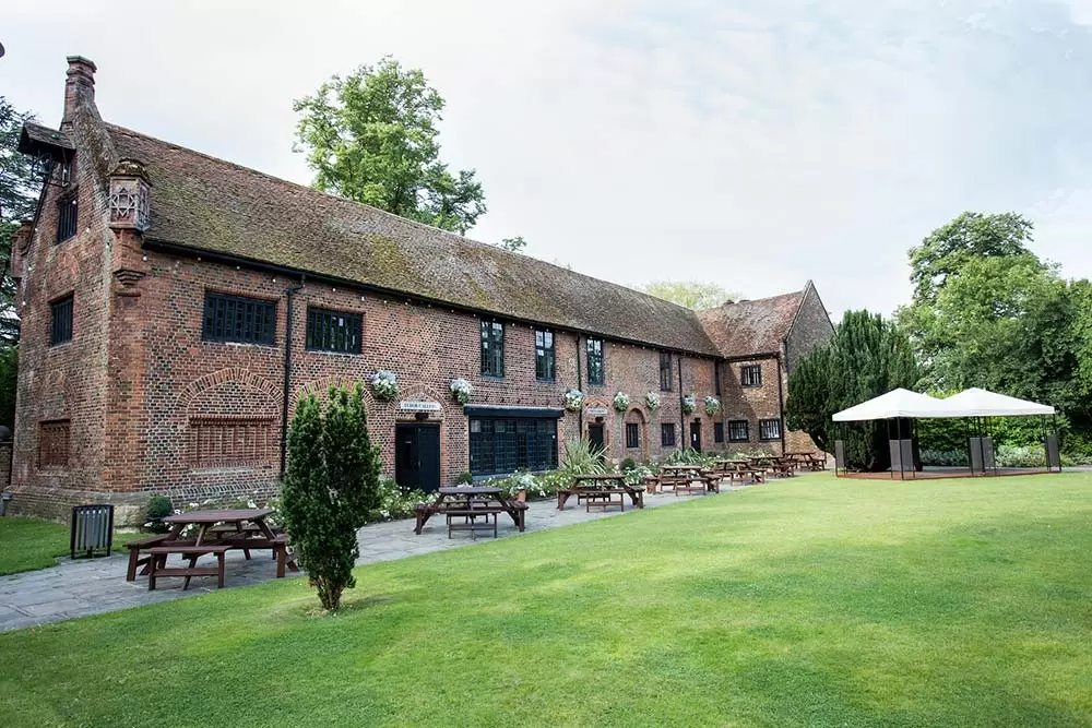 Charming Tudor Barn Eltham lawn venue for outdoor weddings and events.