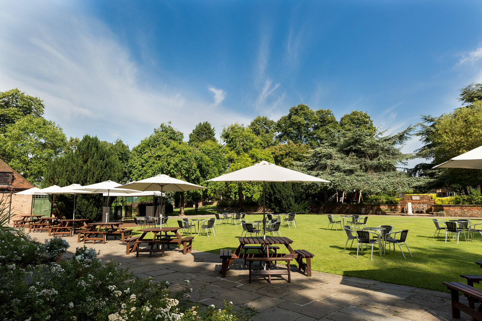 Spacious Tudor Barn Eltham front lawn venue with greenery for outdoor events.