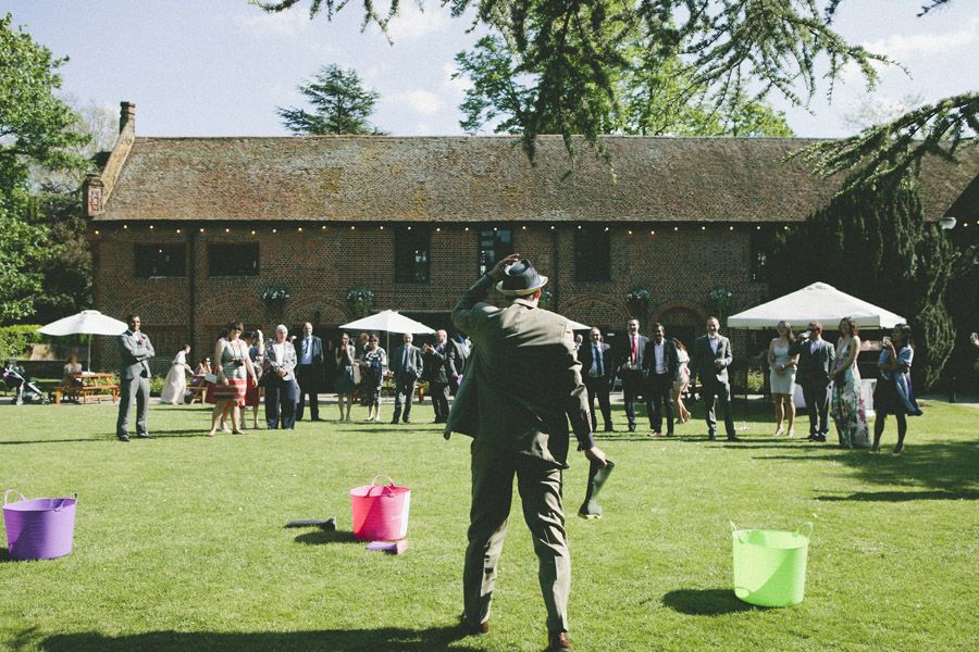 Vibrant outdoor wedding at Tudor Barn Eltham with elegant tents and guests mingling.