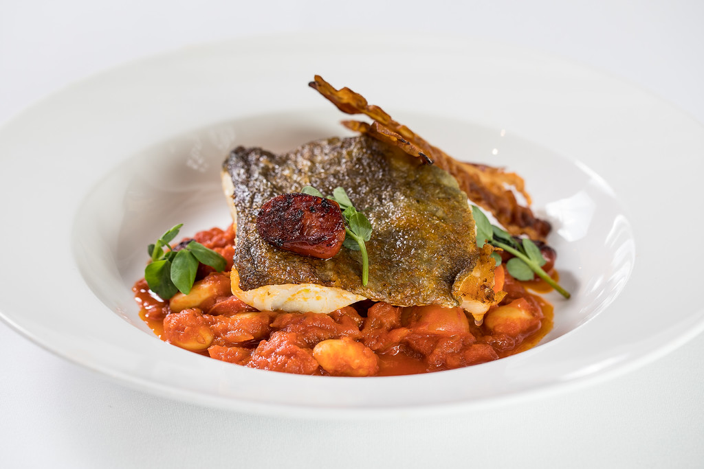 Seared fish dish on bean stew at Gastro Pub, Tudor Barn Eltham - upscale dining event.