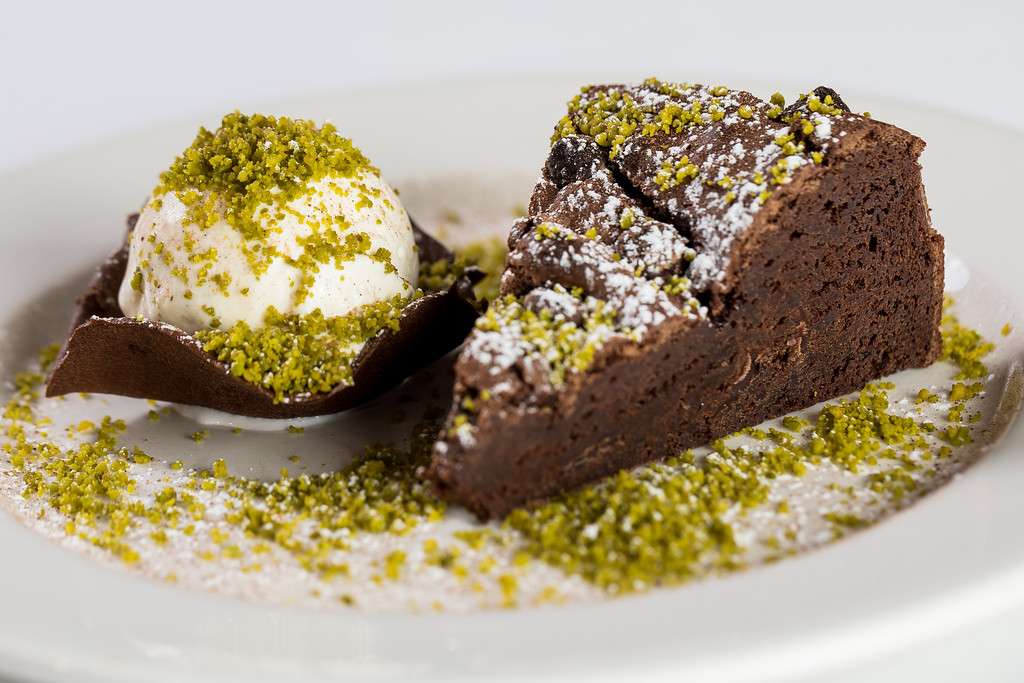 Elegant chocolate cake dessert with vanilla ice cream at Tudor Barn Eltham gastro pub.