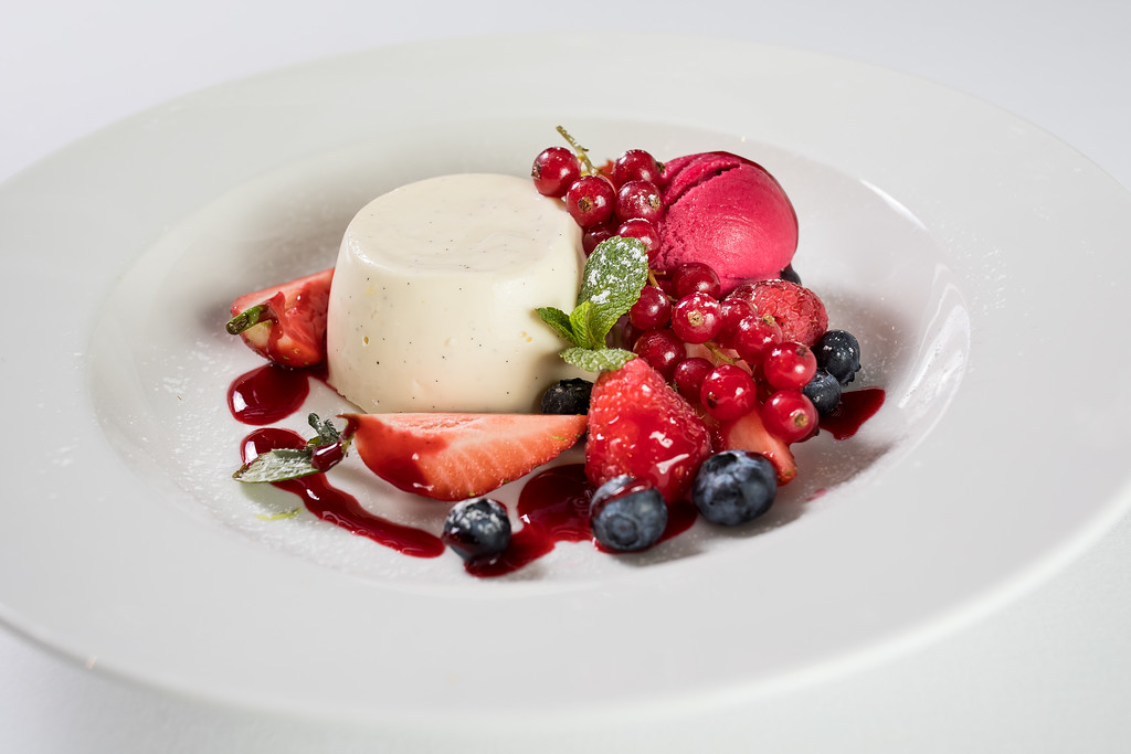 Elegant panna cotta dessert with berries at Gastro Pub, ideal for upscale events.