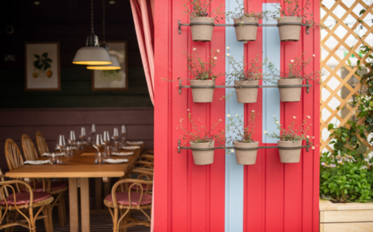 Winter Igloo Experience at 1864 Rooftop Bar with cozy dining setup and vibrant decor.