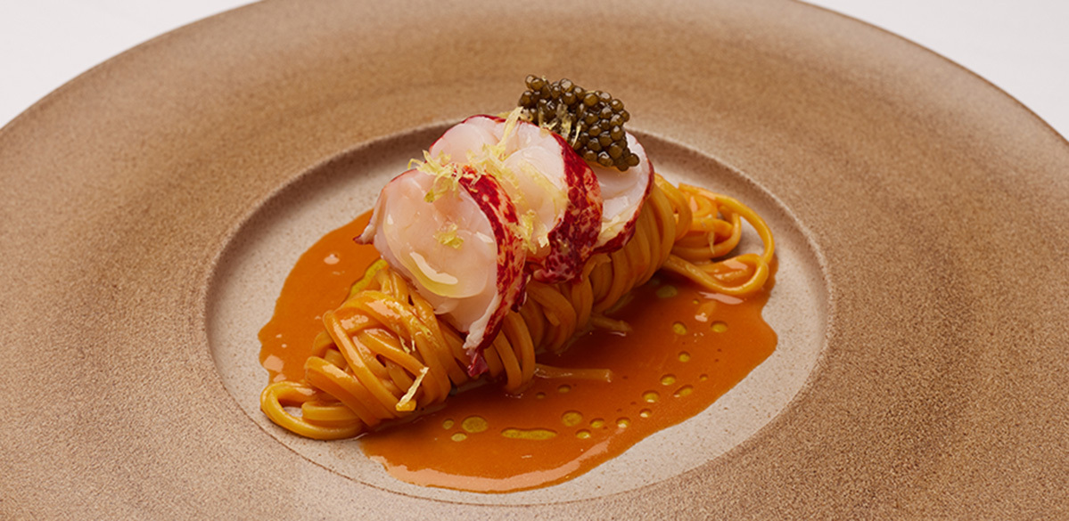 Gourmet lobster pasta dish with caviar, perfect for upscale events and catering.