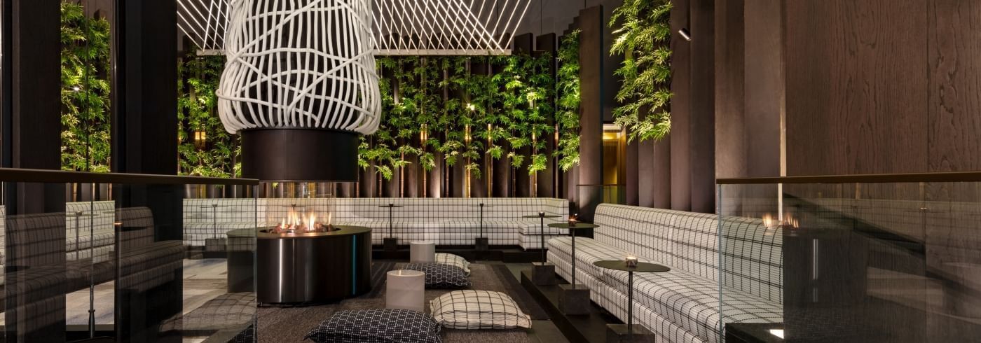 Stylish lounge at Shima Gardens, ideal for networking events with cozy seating and greenery.