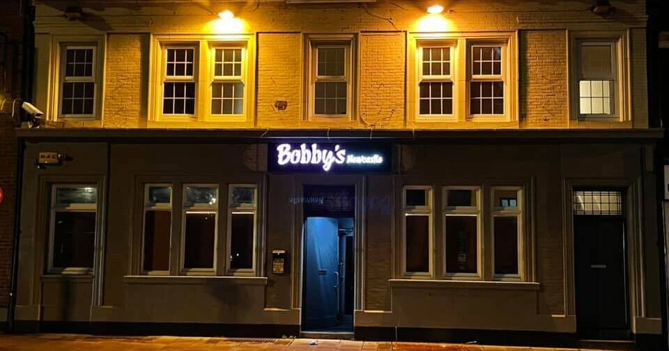 Bobby's Bar exterior with illuminated sign, perfect for casual gatherings and networking events.