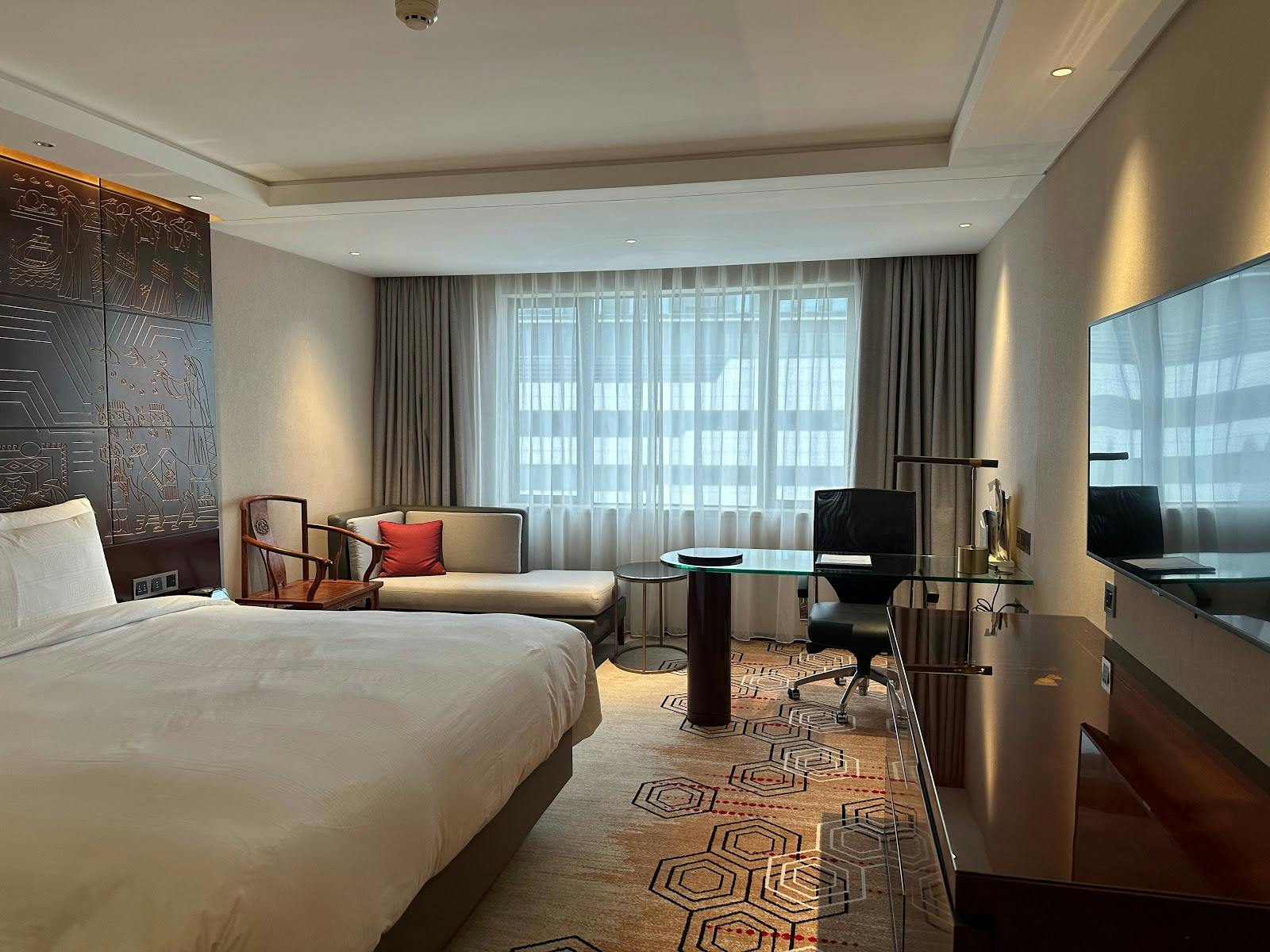 Modern hotel room in China Hotel, Guangzhou with a comfortable bed for business travelers.