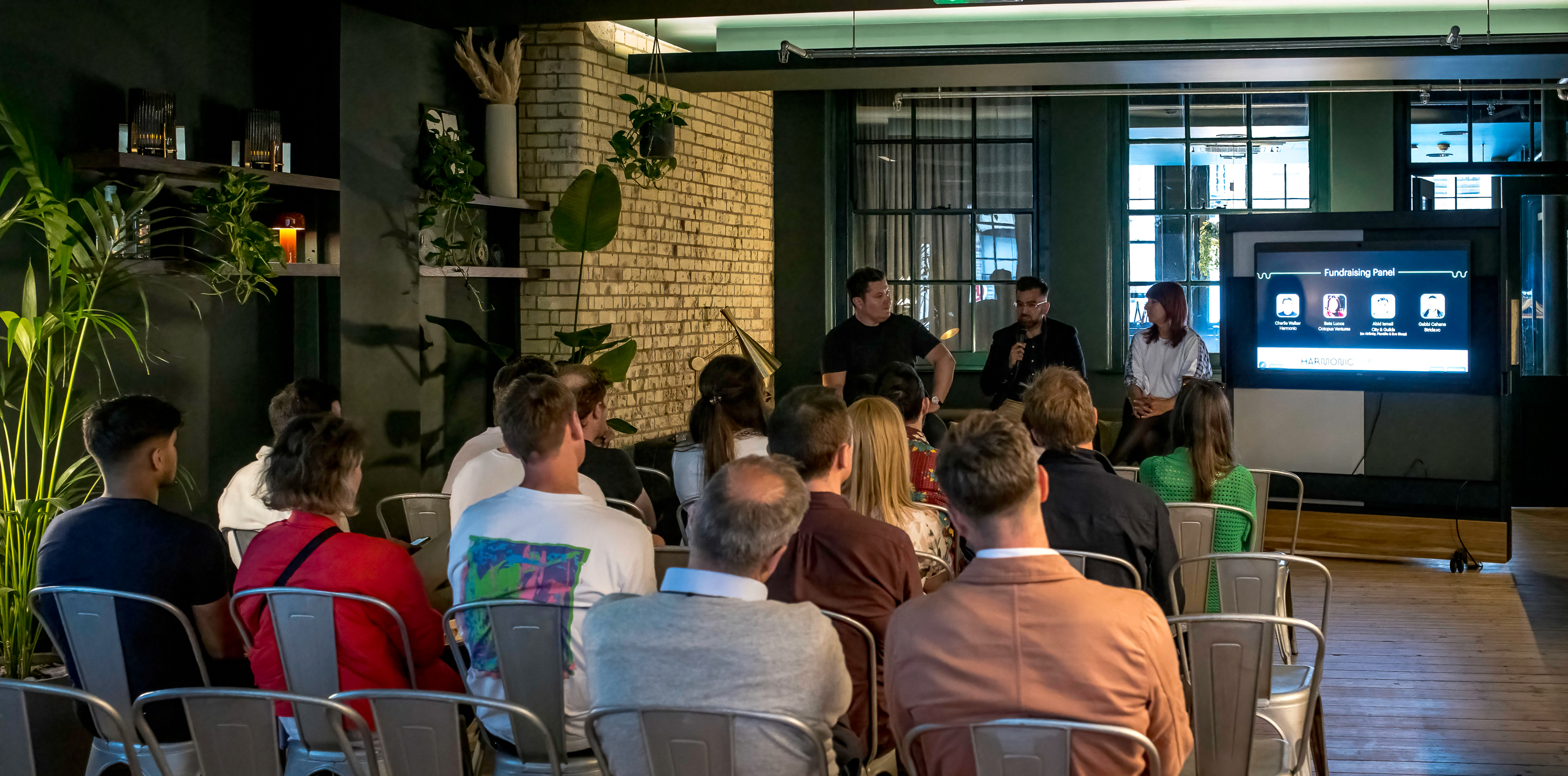 Modern event space in Shoreditch with greenery, perfect for panel discussions and networking.