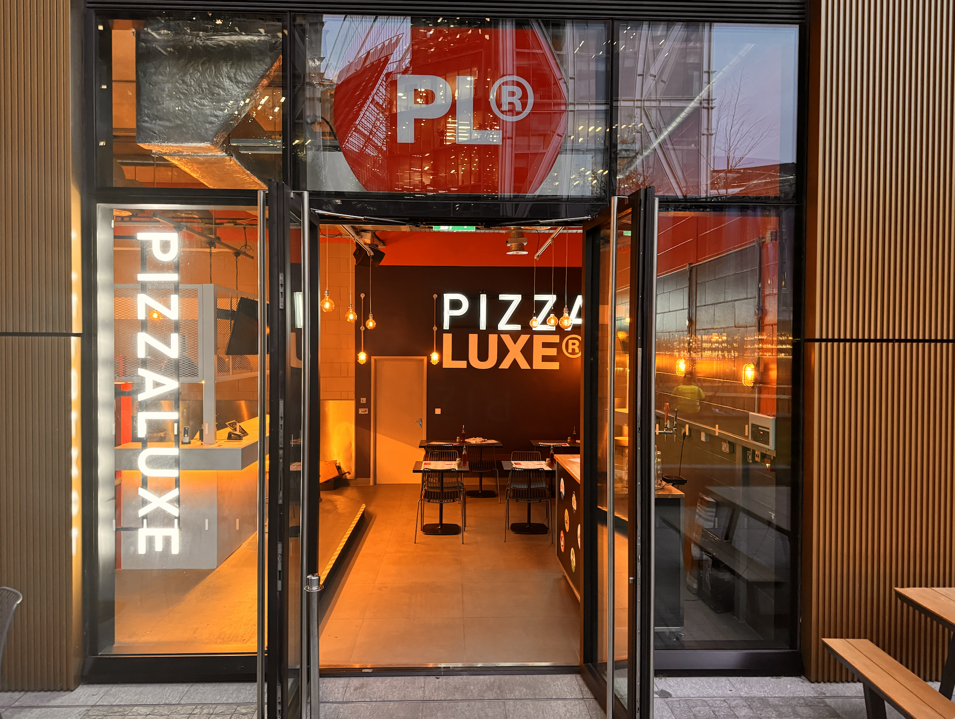 Modern entrance of PizzaLuxe, ideal for casual meetings and food events.