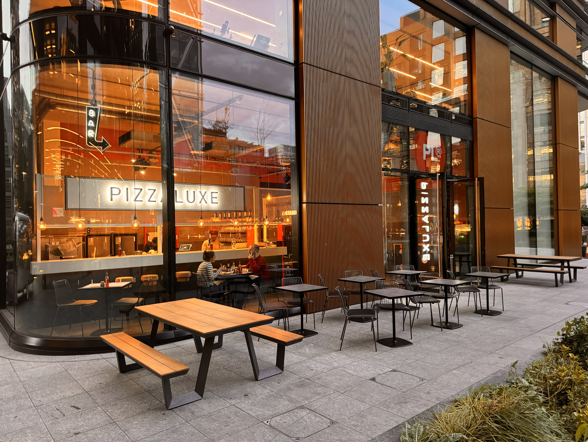 Modern dining venue with outdoor seating for casual meetings at PizzaLuxe Principal Place.