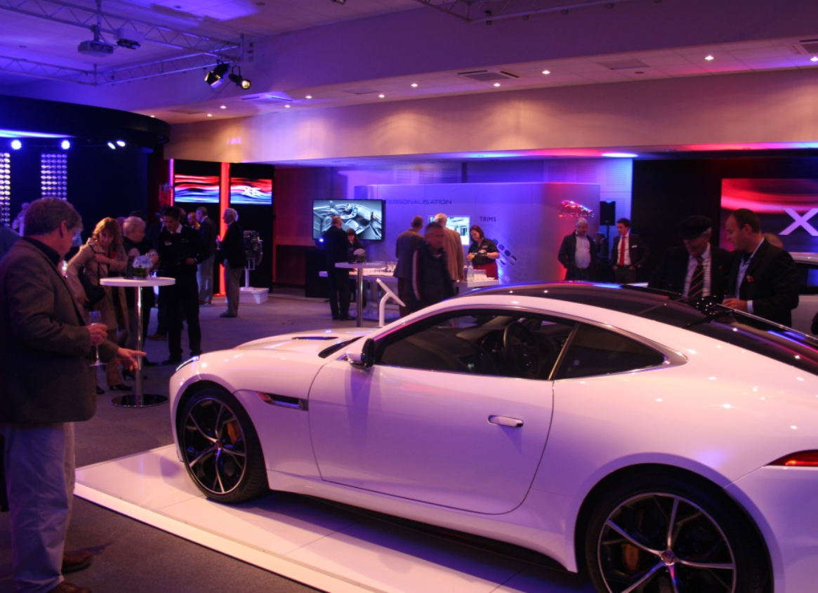 Luxury car centerpiece in upscale Haynes Motor Museum meeting room for automotive events.