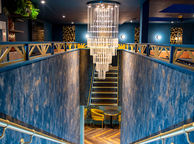 Elegant ZOYA GRILL & LOUNGE with chandelier, ideal for upscale events and gatherings.