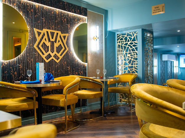 Modern event space at ZOYA GRILL & LOUNGE with elegant yellow seating for gatherings.