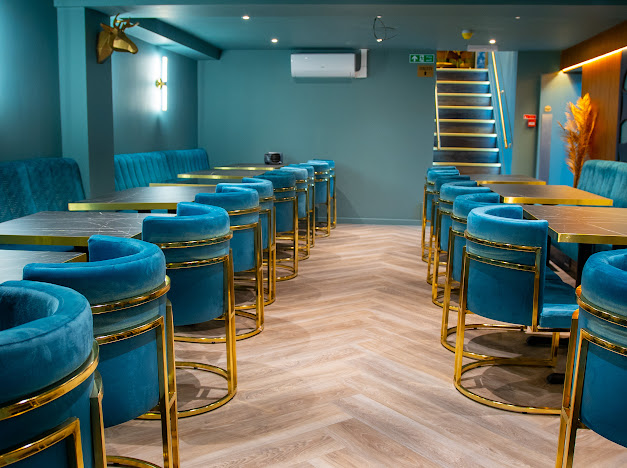 Stylish ZOYA GRILL & LOUNGE event space with teal seating for gatherings and networking.