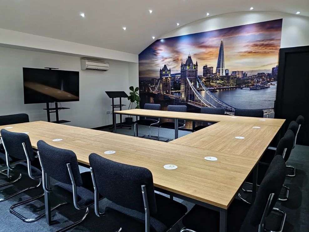 Modern London conference room with U-shaped table for workshops and meetings.