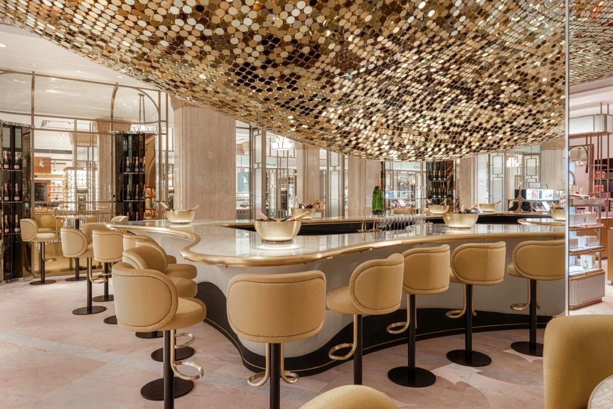 Elegant bar area with gold-accented ceiling, perfect for cocktail receptions and networking events.
