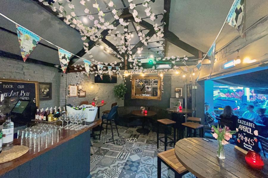 Pirates Cave at Sugar Cane Tiki Bar, cozy event space with string lights for gatherings.