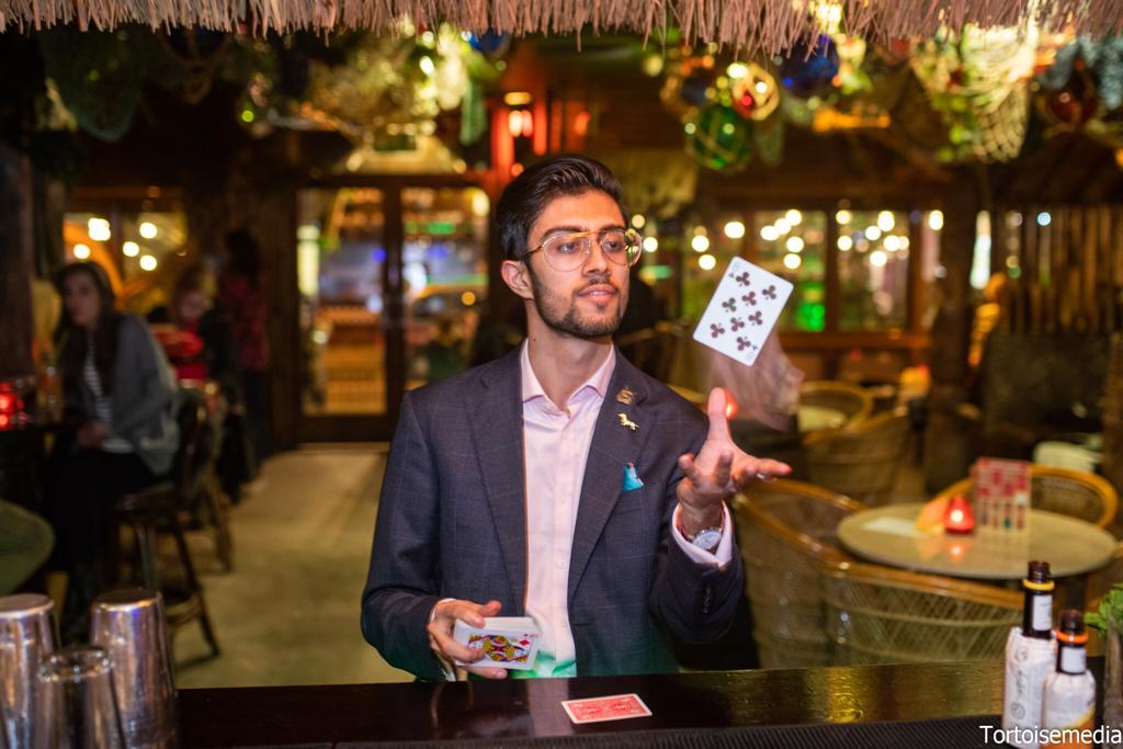 Magician performing at Kai Wai Cove, Sugar Cane Tiki Bar for an engaging event experience.