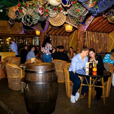 Tiki Cocktail Bar with bamboo decor, perfect for networking events and social gatherings.