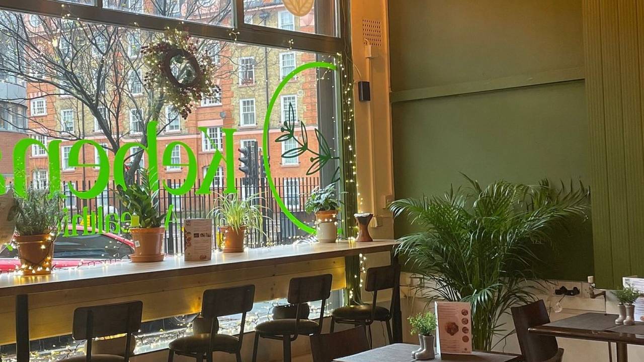 Cozy Kebena Green restaurant with large windows, perfect for meetings and events.