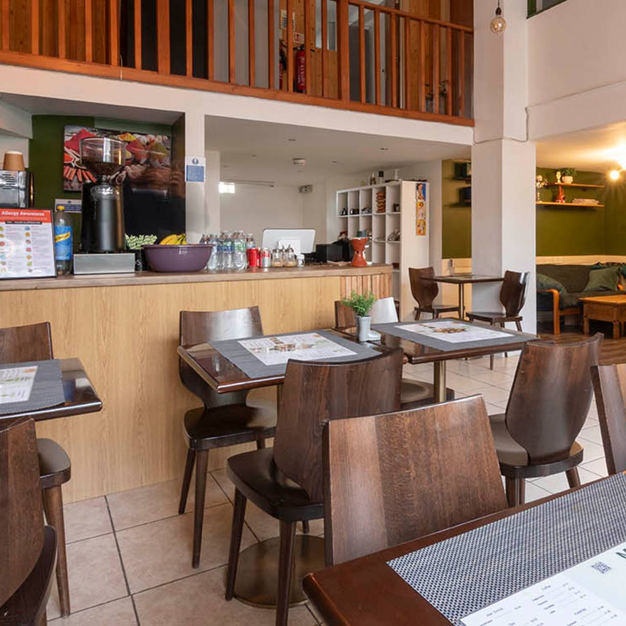 Cozy café in Kebena Green with wooden tables, perfect for informal meetings and events.