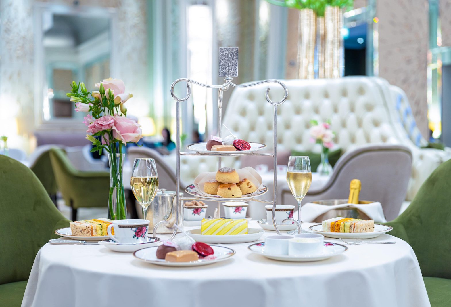Elegant high tea setup with pastries at Palm Court, The Langham, London.