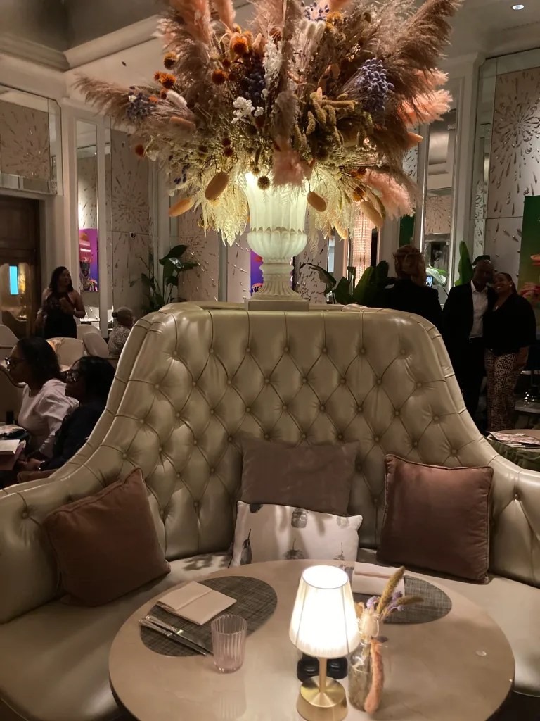 Elegant floral arrangement centerpiece in Palm Court, The Langham, London for upscale events.