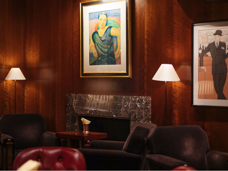 Le Magritte Bar & Terrace: elegant lounge with warm wood paneling for networking events.