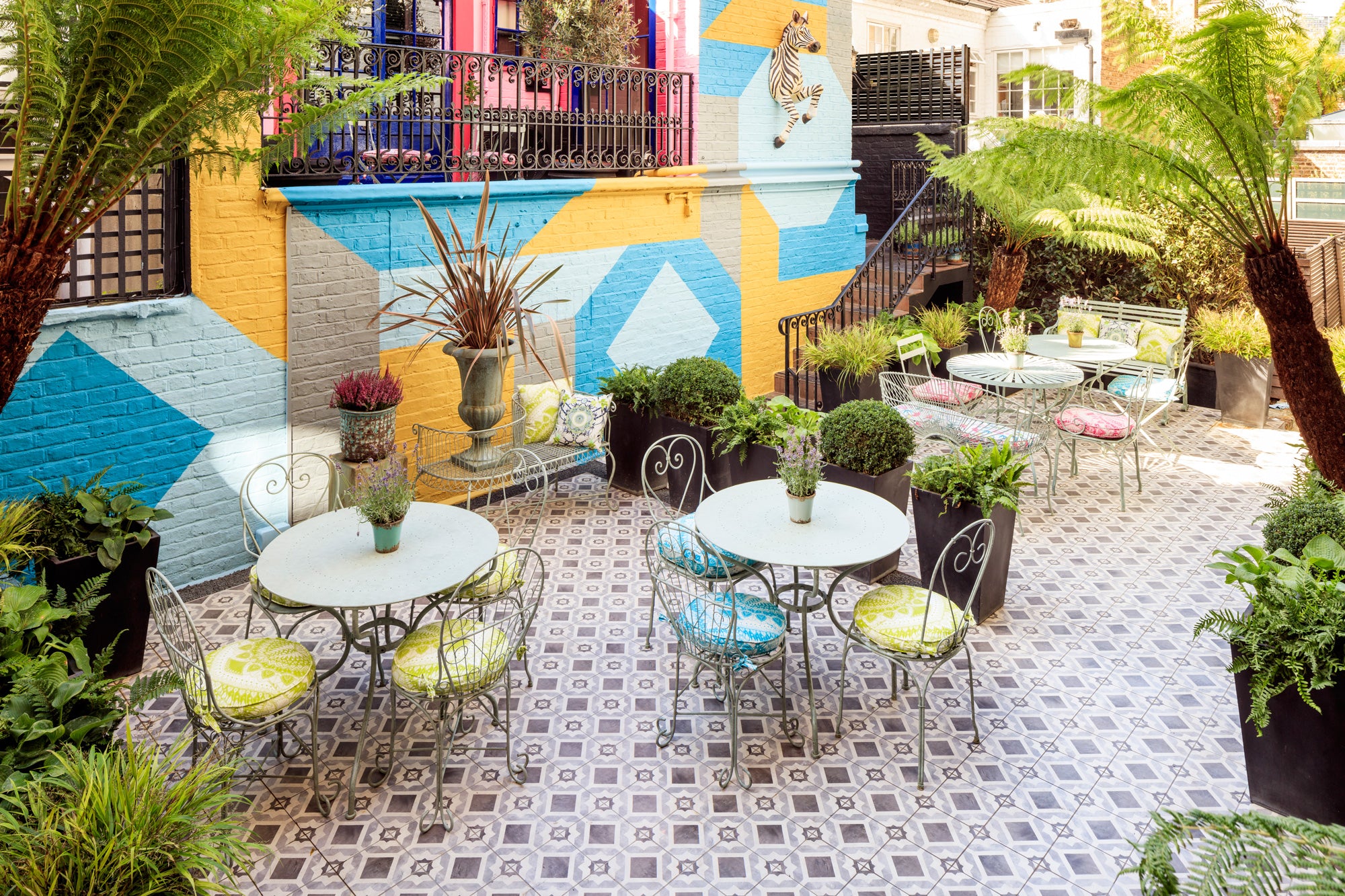Vibrant outdoor event space at Blakes Hotel London with lush greenery and stylish seating.