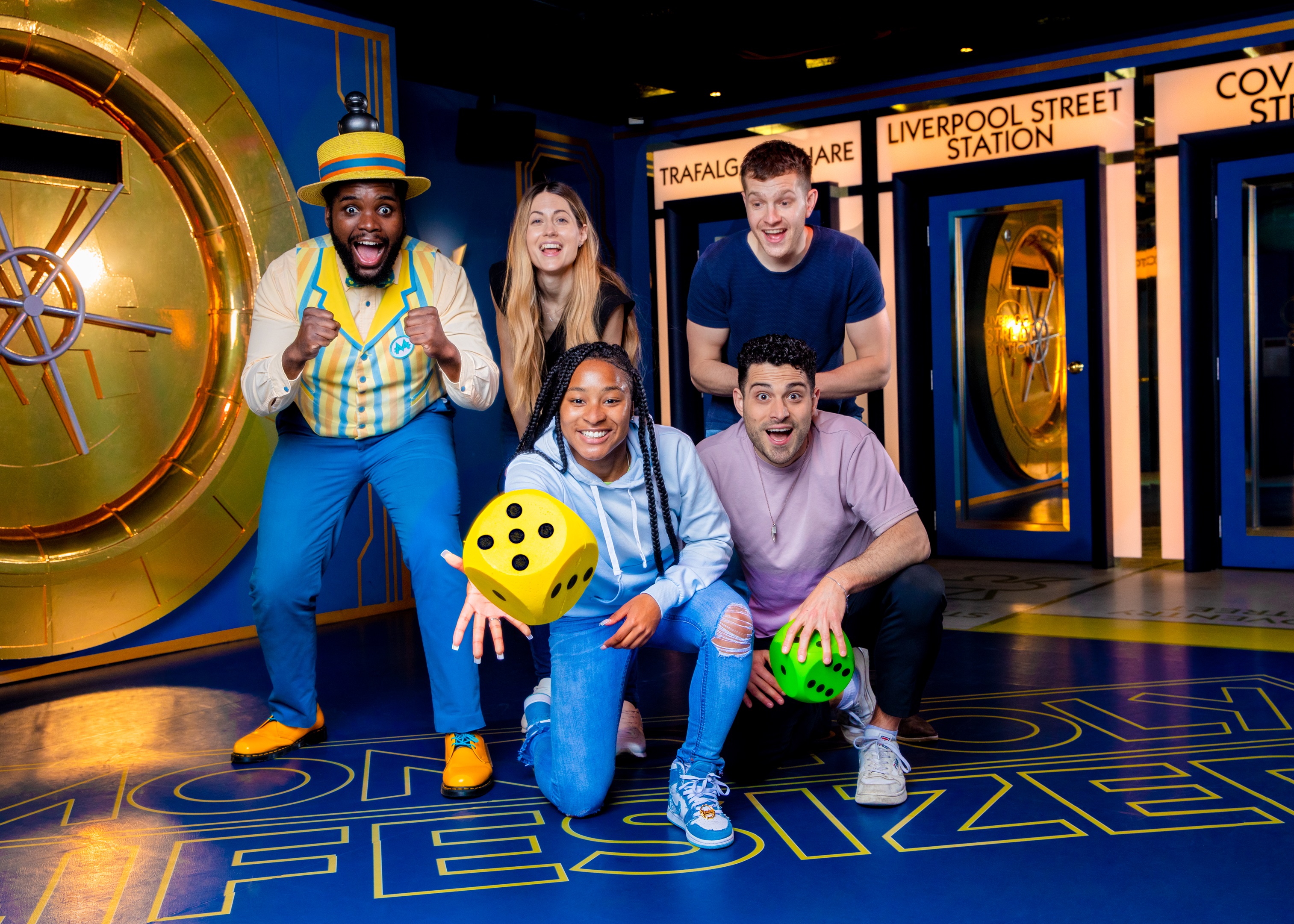 Team-building event with participants using oversized dice in Monopoly Lifesized.