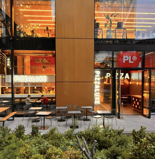 Modern dining venue at PizzaLuxe Manchester Arndale with outdoor seating for events.