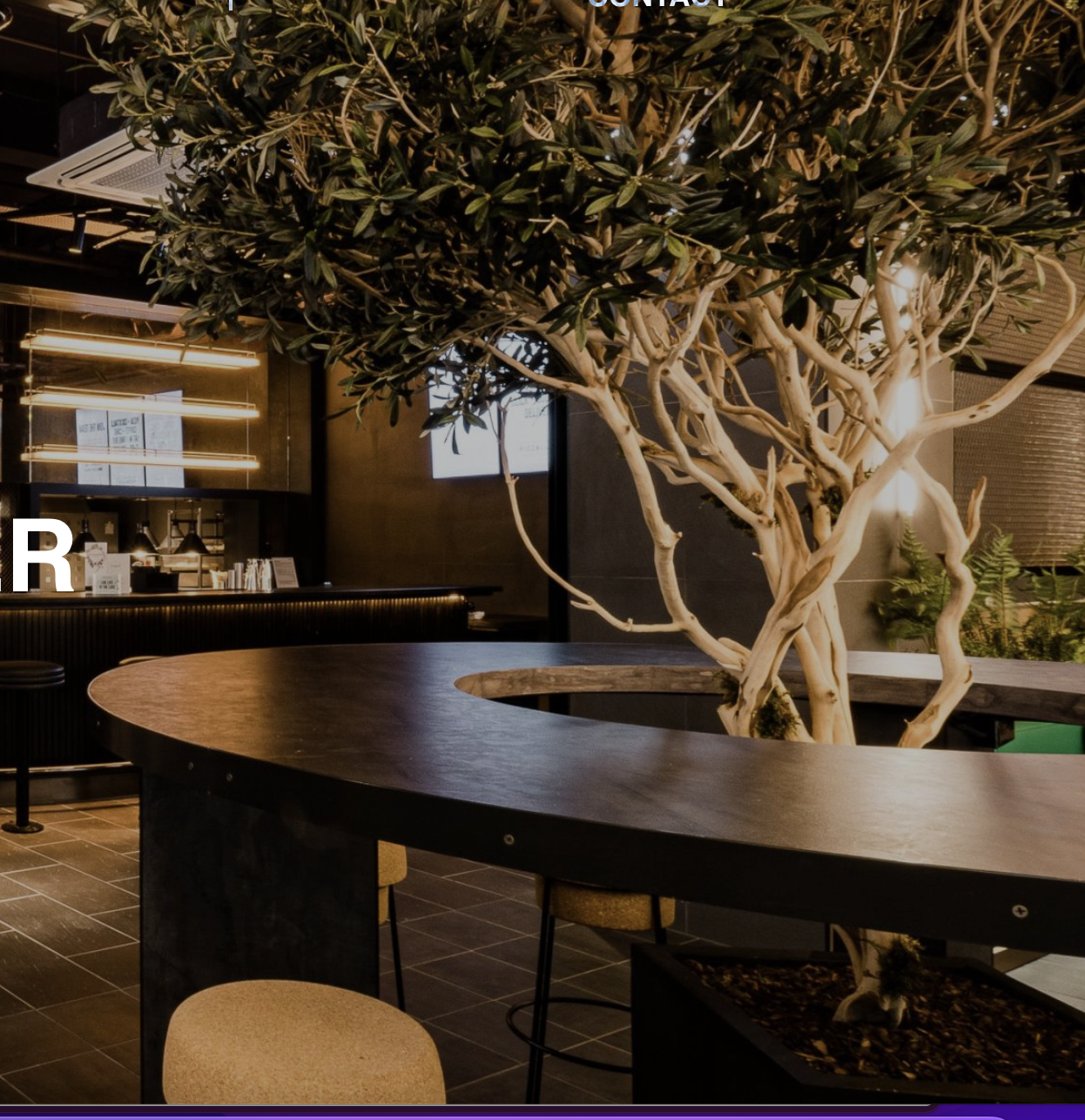 Modern event space at PizzaLuxe Manchester with artistic tree centerpiece, ideal for networking.