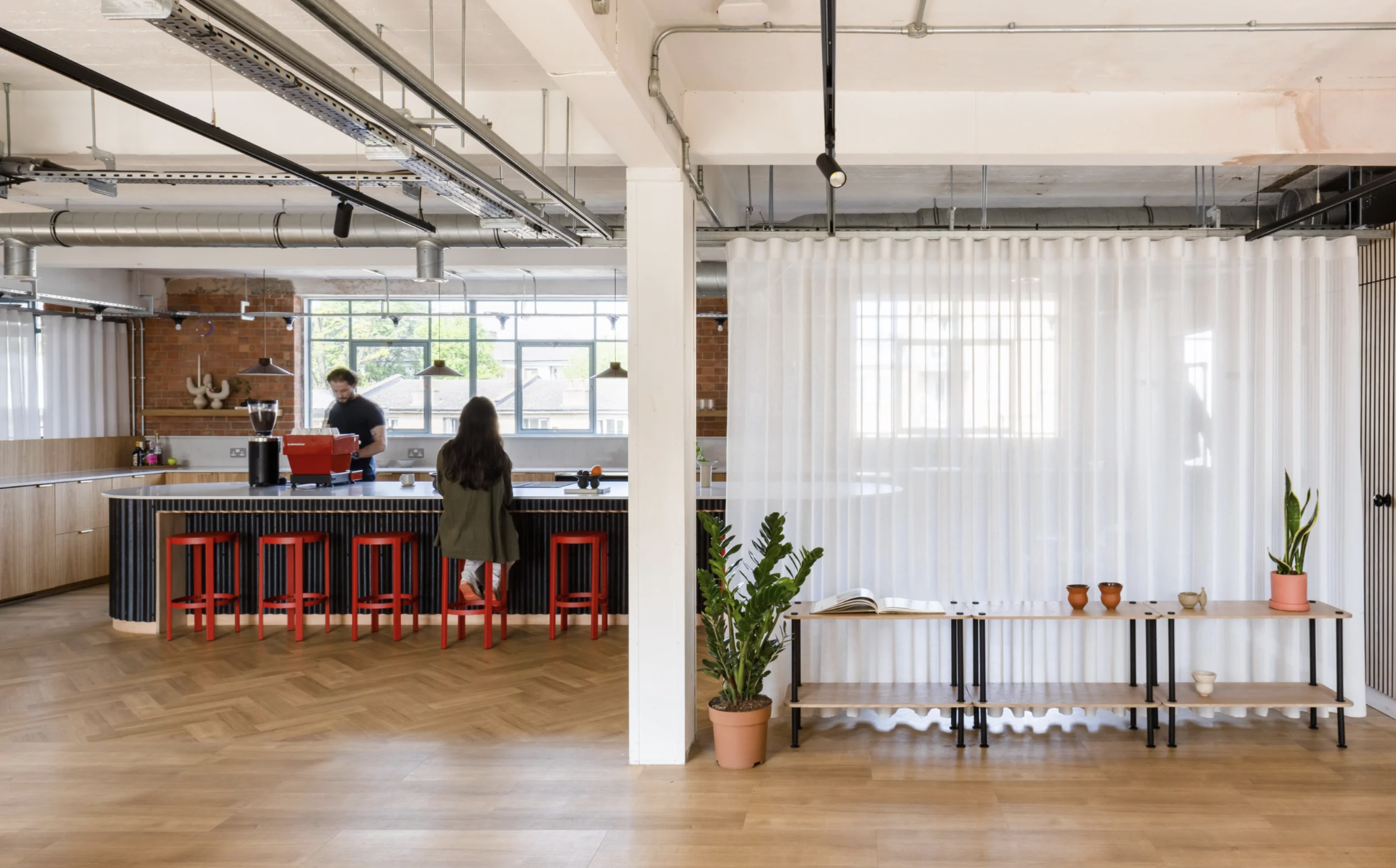 Modern open-concept workspace with bar seating for informal meetings and events.