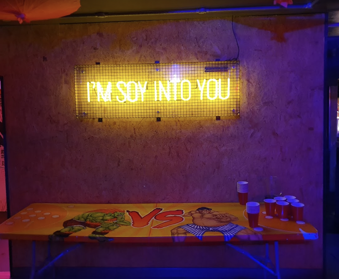 Vibrant Tokyo Joe's event space with neon sign, perfect for casual parties and networking.