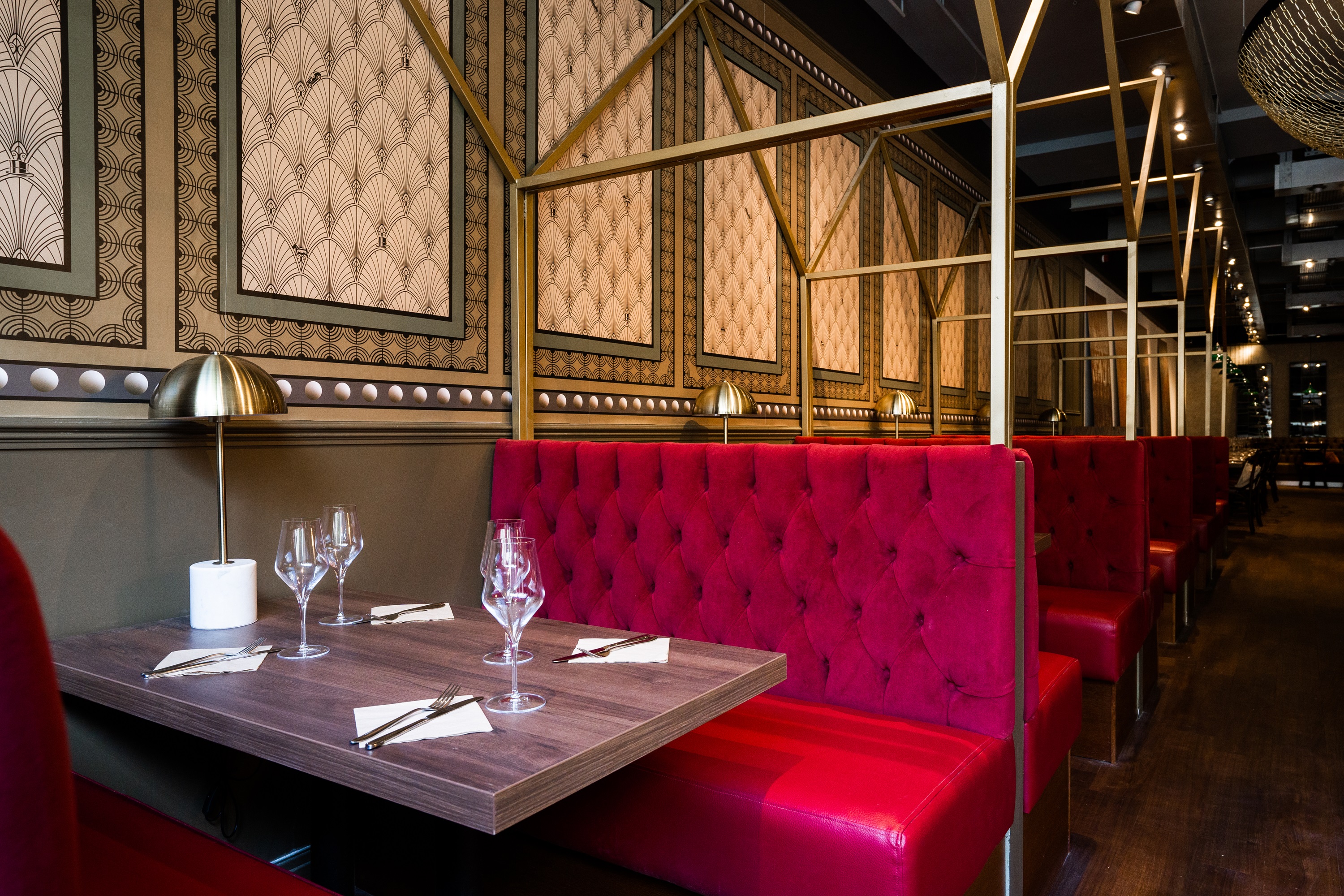 Stylish Top Hat Restaurant interior with plush red booths for exclusive events.