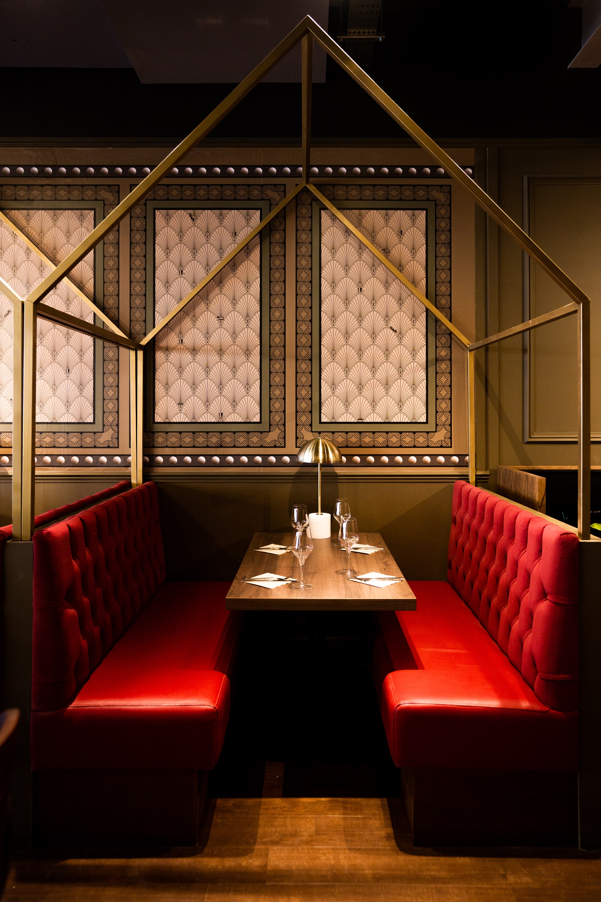 Elegant semi-private dining space with plush red booths for intimate events.