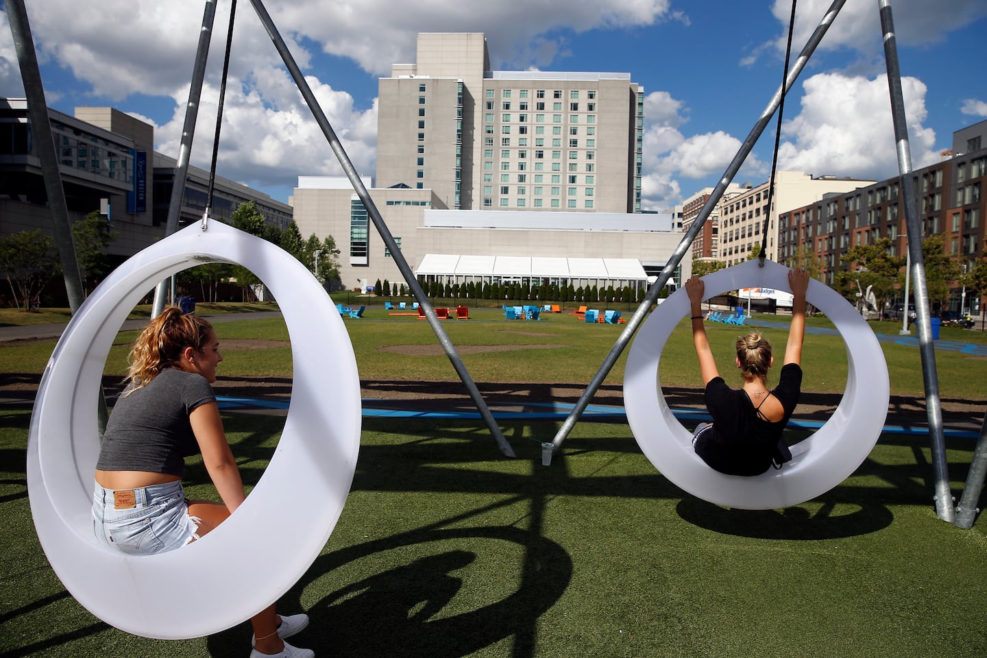 Vibrant outdoor networking space with unique swings at The Lawn On D for events.