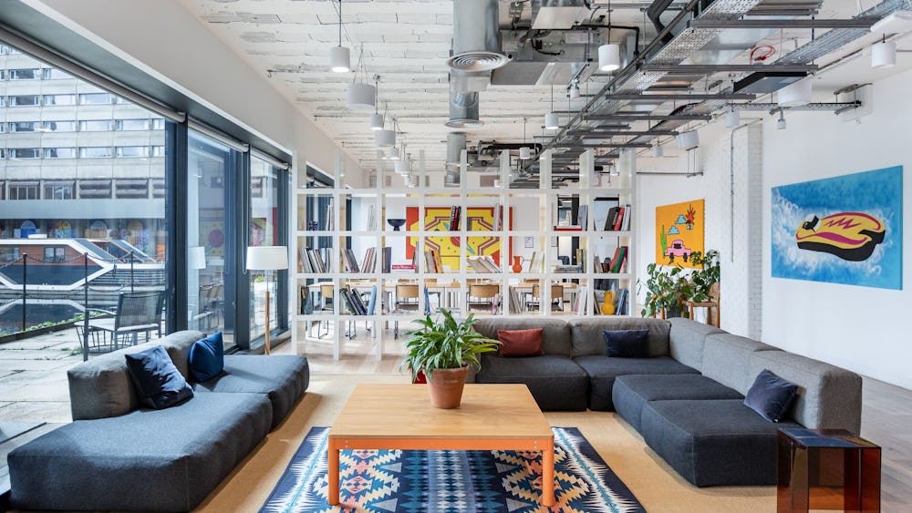 Modern WeWork meeting room with comfortable seating for networking events.