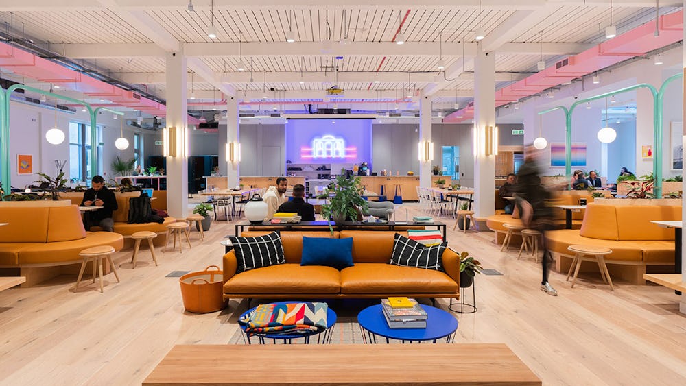 Modern WeWork meeting room with vibrant decor, ideal for workshops and networking events.
