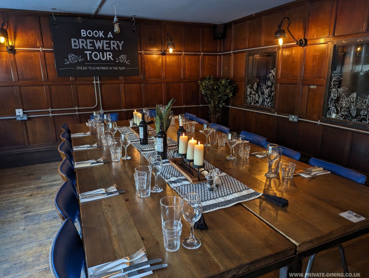 Private dining room with elegant wooden table, ideal for corporate events and gatherings.