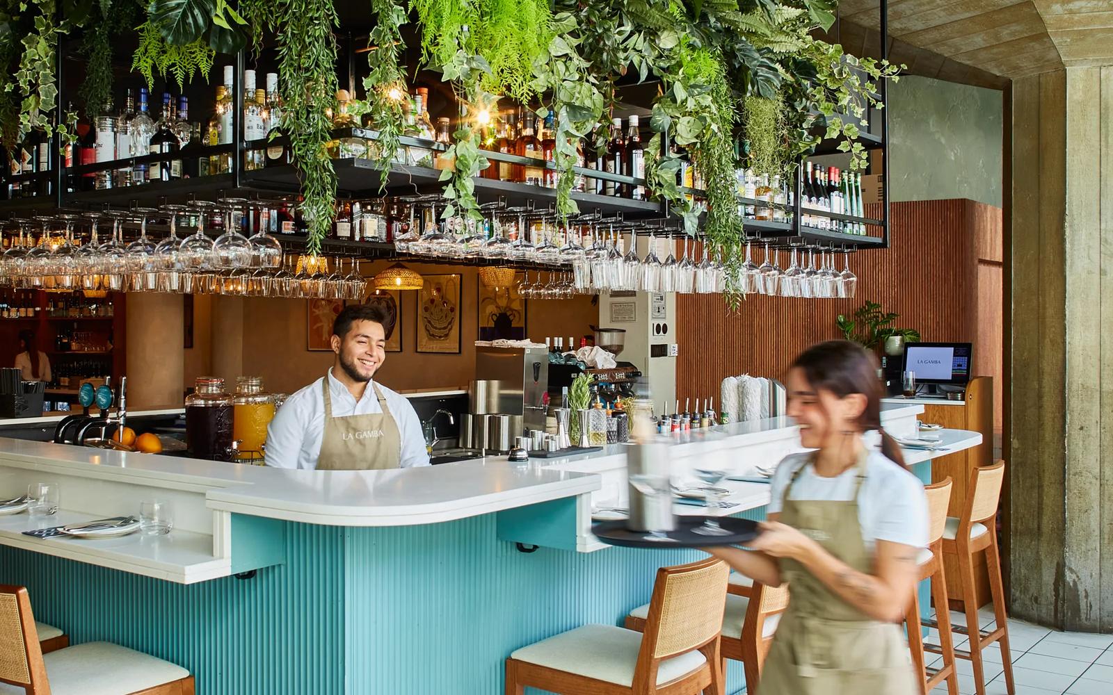 Vibrant bar in La Gamba with lush greenery, perfect for events and social gatherings.