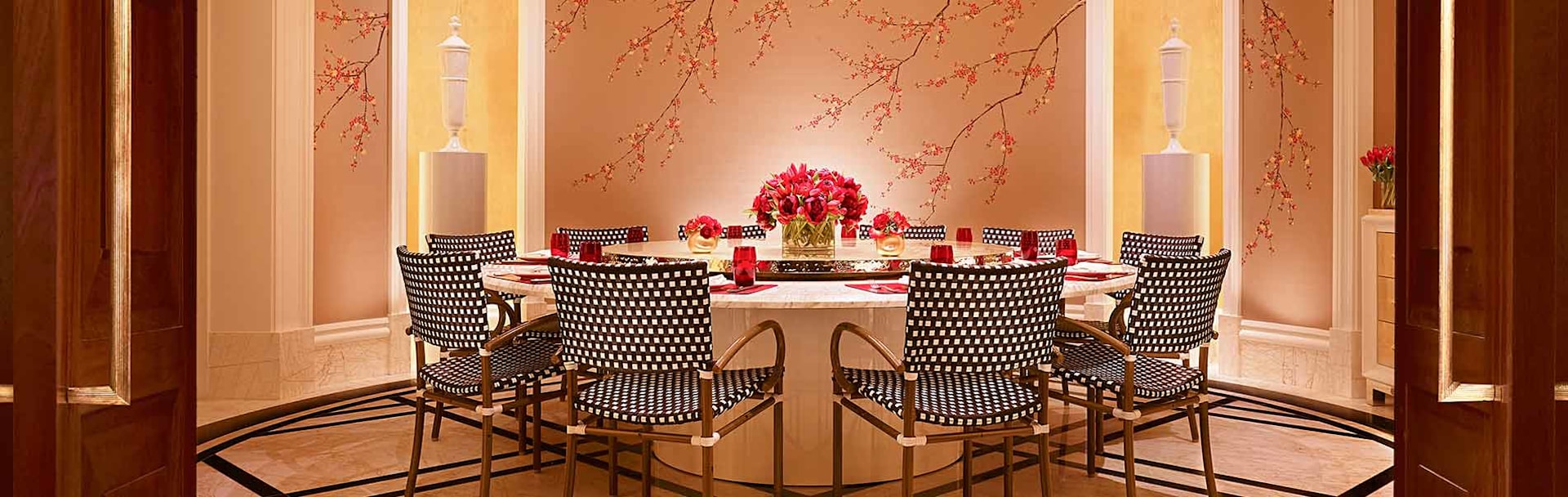 Elegant Executive Boardroom at Encore Boston Harbor with round table and floral centerpiece.