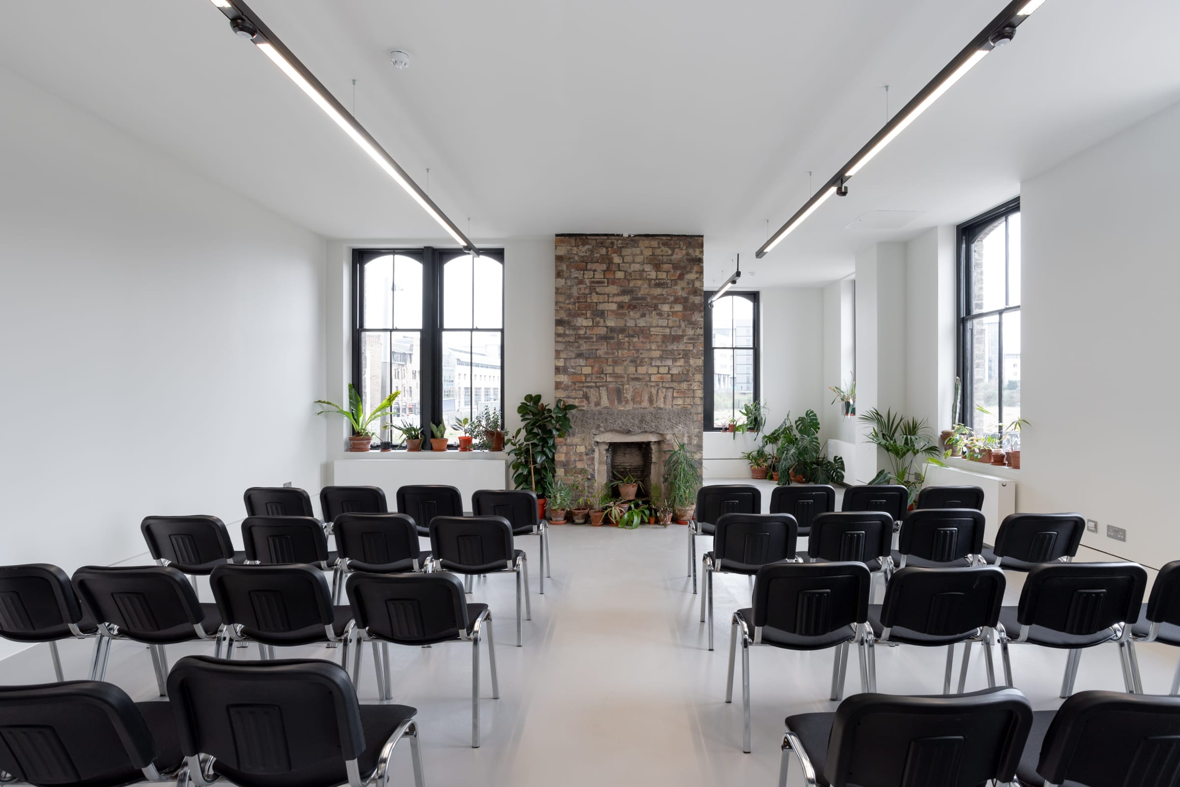 Versatile meeting space with natural light and greenery at Edinburgh Printmakers.