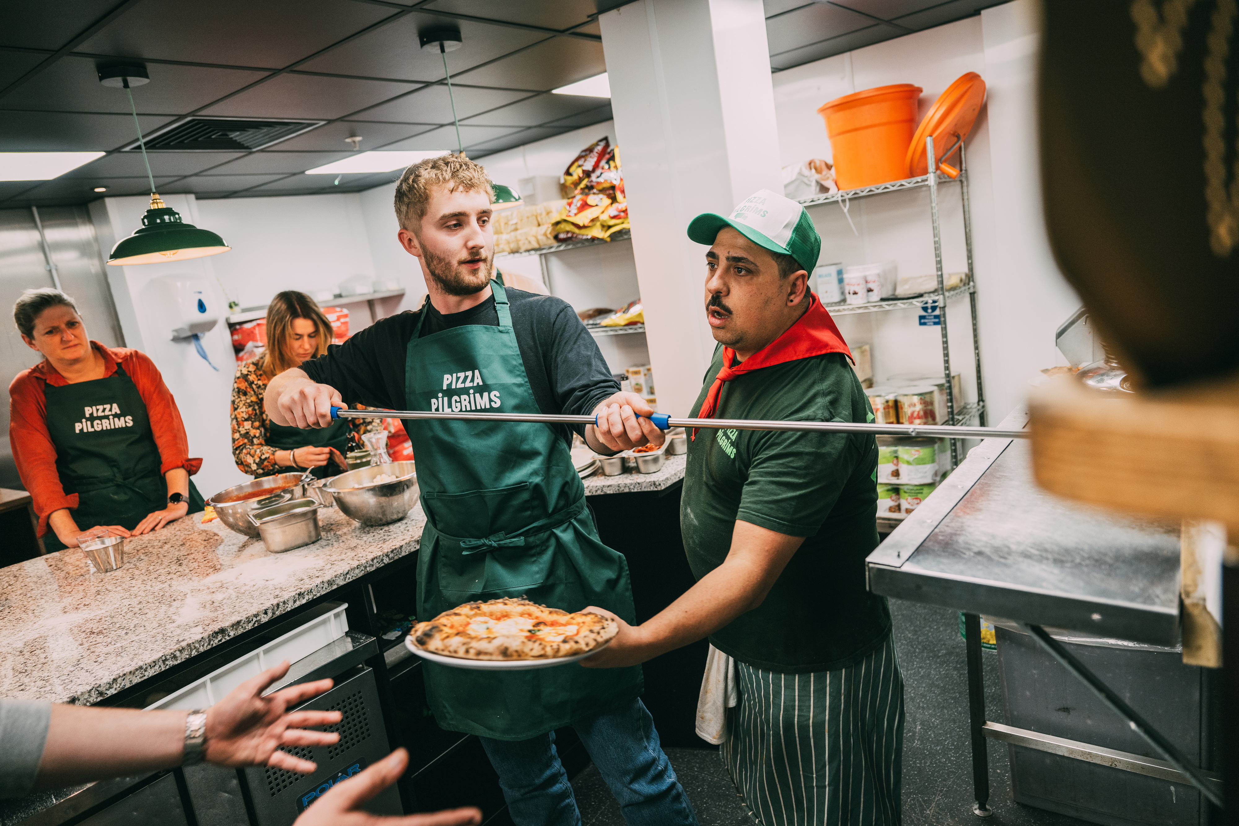 Team-building pizza making event at Dough It Yourself, fostering creativity and collaboration.