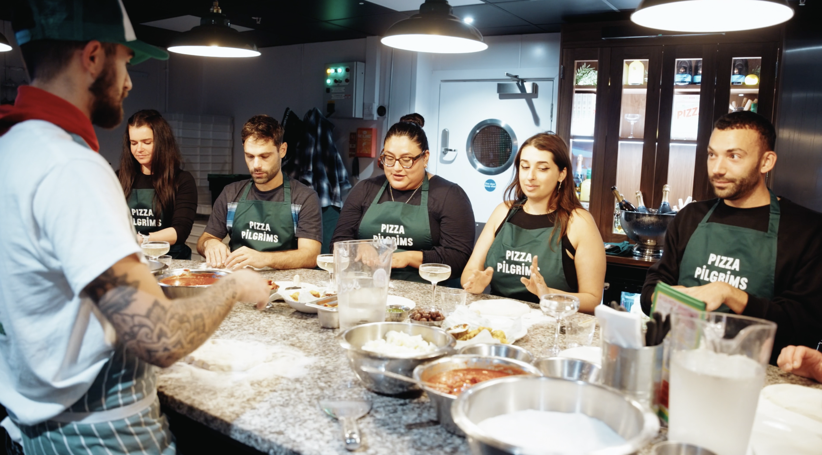 Group pizza-making class at Dough It Yourself, perfect for team-building events.