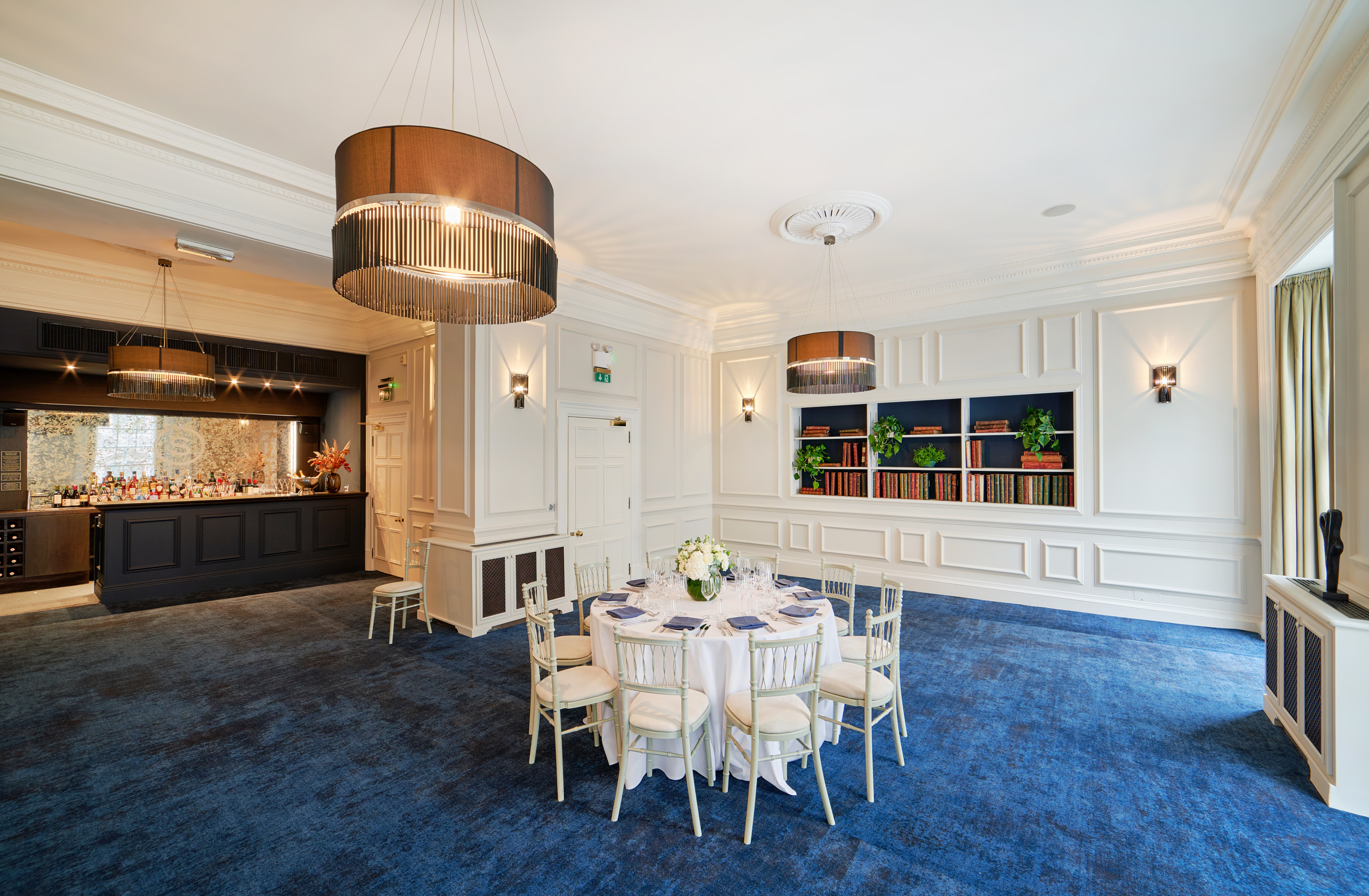 Elegant event space with round table, chandeliers for corporate functions and private celebrations.