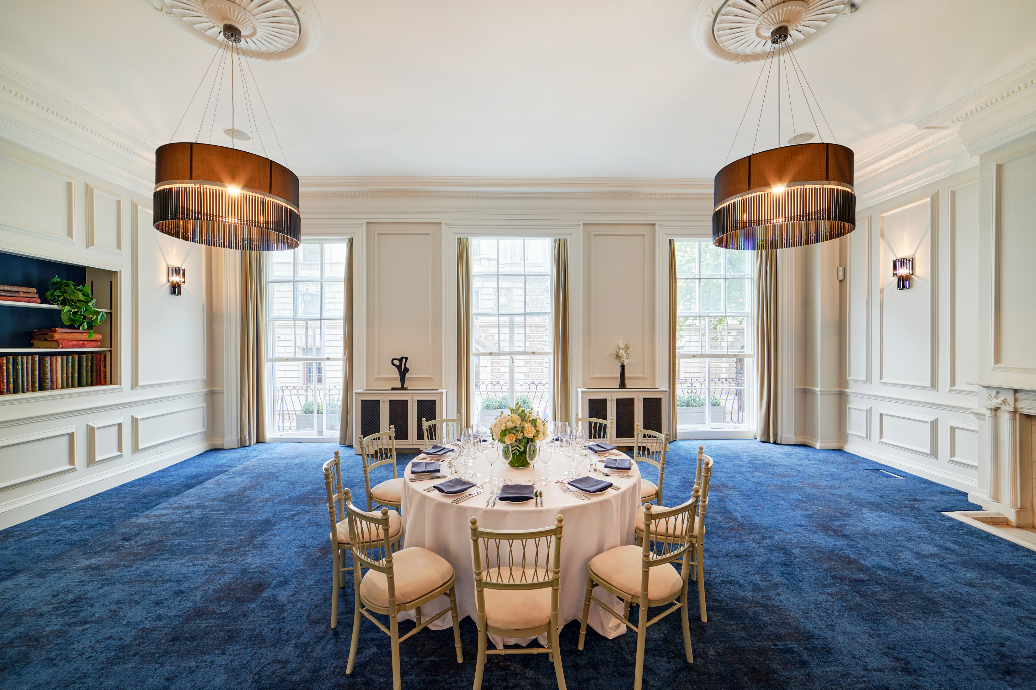 Elegant meeting space with round table, ideal for corporate events and private dinners.