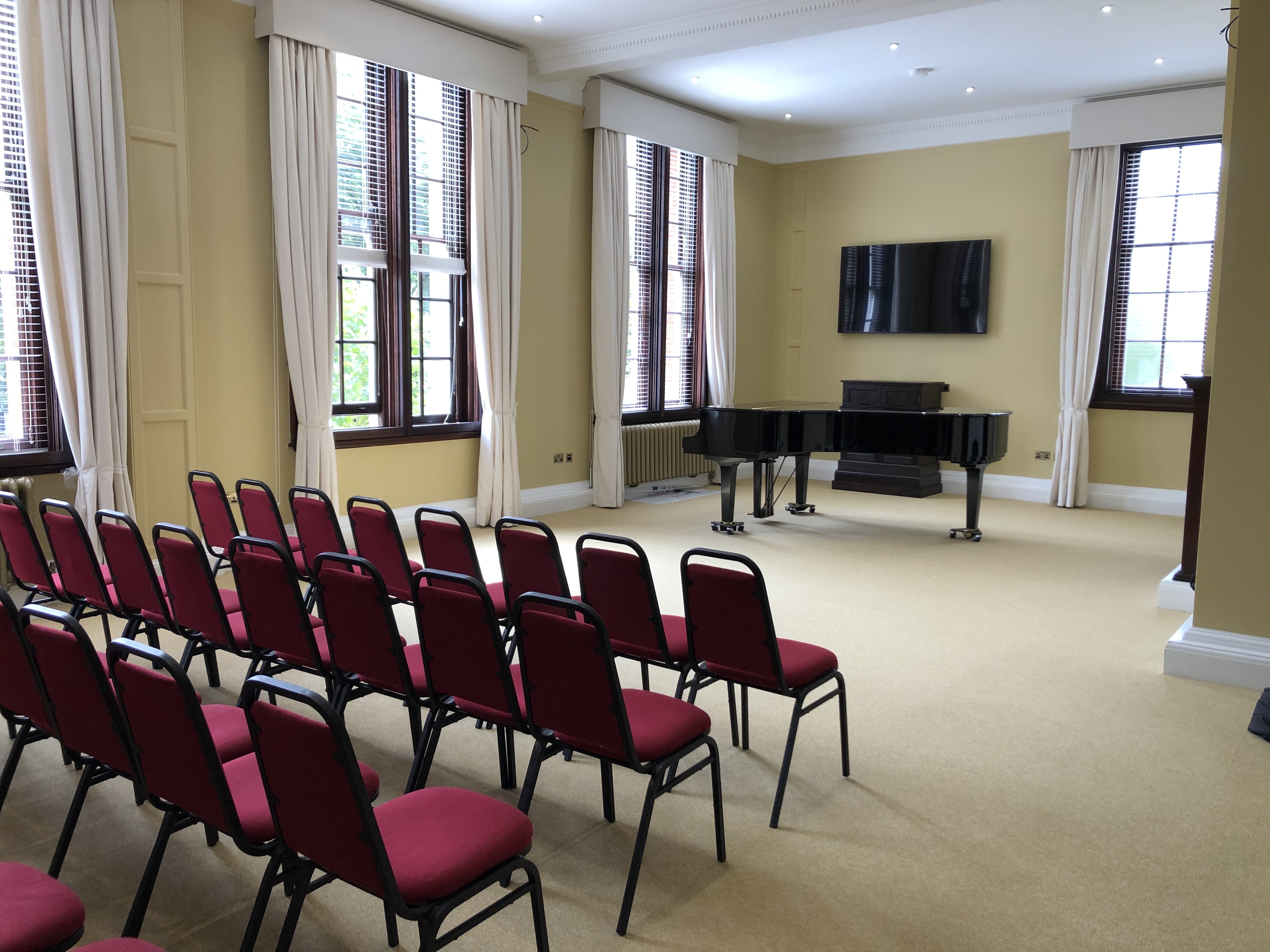 Forsyth Room at Royal Academy of Music with red chairs, ideal for workshops and presentations.