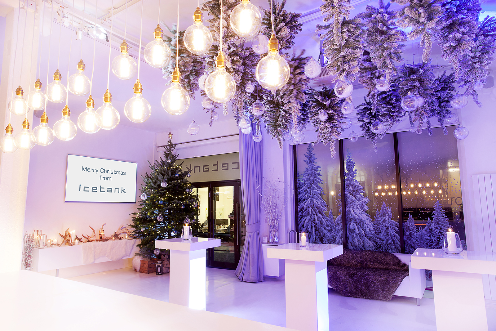 Christmas party venue with elegant decor and a prominent tree for festive gatherings.